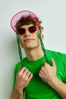 handsome guy green t-shirt decoration fashion glasses isolated background photo