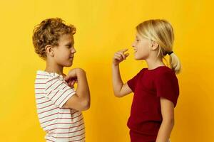 Portrait of cute children cuddling fashion childhood entertainment on colored background photo