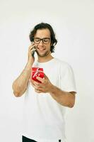 Cheerful man talking on the phone gift box isolated background photo