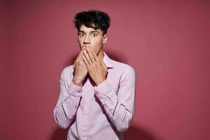 Photo of romantic young boyfriend in a pink shirt gesturing with his hands Lifestyle unaltered