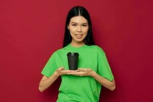 woman posing in a green t-shirt disposable black glasses red background unaltered photo