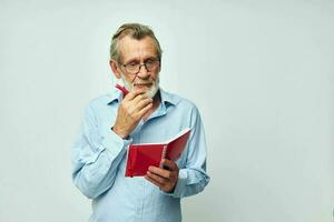 old man writes down emotions in a notebook light background photo