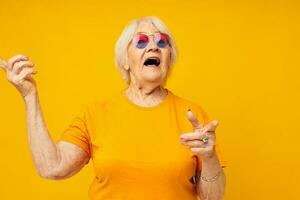 Photo of retired old lady happy lifestyle in yellow t-shirts cropped view