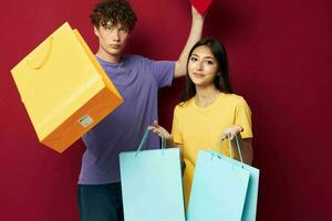 cute young couple shopping bags in hand isolated background unaltered photo