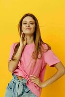 Young woman pink t-shirts and denim shorts posing isolated background photo