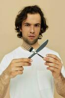 Attractive man emotions knife and fork kitchenware isolated background photo