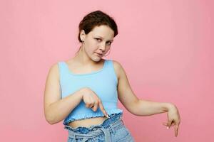 pretty woman grimace close-up emotions earrings posing pink background unaltered photo