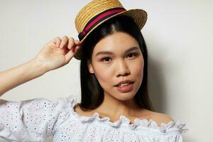 Portrait Asian beautiful young woman hat in hand posing smile isolated background unaltered photo