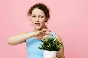 pretty woman potted flower posing plant pink background unaltered photo