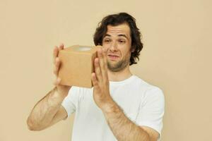 handsome man holding a cardboard small box in his hands photo