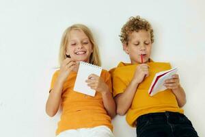 two joyful children emotions drawing together notepad and pencils childhood lifestyle unaltered photo