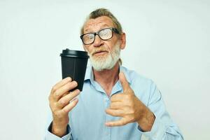 old man gestures with his hands a glass of drink isolated background photo