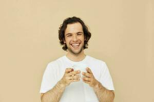 Cheerful man with a white mug in his hands emotions posing isolated background photo