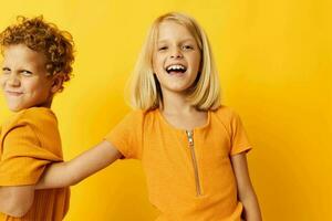 picture of positive boy and girl cuddling fashion childhood entertainment on colored background photo