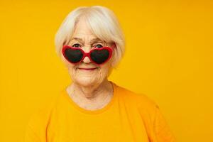 elderly woman happy lifestyle in yellow t-shirts glasses close-up emotions photo