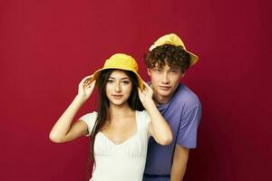Man and woman in colorful t-shirts stylish clothes hats isolated background photo