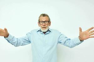 Photo of retired old man in blue shirts gestures with his hands cropped view