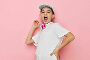 pretty young girl headphones in a white t-shirt and a cap childhood unaltered photo