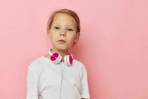 Portrait of happy smiling child girl fun posing headphones childhood unaltered photo