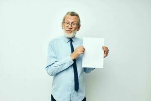 Portrait elderly man holding documents with a sheet of paper cropped view photo