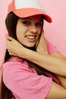 smiling woman pink t-shirts with cap on her head fashion summer style photo