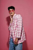 portrait of a young man self confidence pink plaid blazer fashion posing pink background unaltered photo