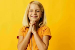 cute little girl blonde straight hair posing smile fun yellow background unaltered photo