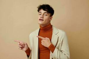 A young man posing with a phone in his hands in a jacket elegant style Lifestyle unaltered photo