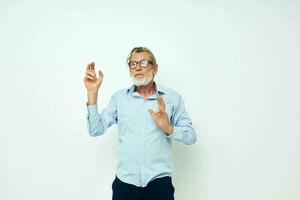 Senior grey-haired man in shirt and glasses posing emotions light background photo