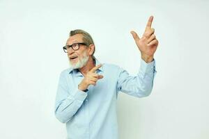 Portrait of happy senior man in shirt and glasses posing emotions cropped view photo