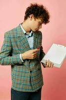 portrait of a young curly man in a plaid jacket copy-space folder isolated background unaltered photo