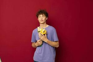 young guy red hair in casual wear bouquet of flowers gift red background unaltered photo