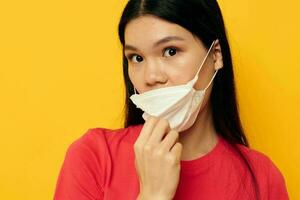 Portrait Asian beautiful young woman posing medical mask close-up isolated background unaltered photo