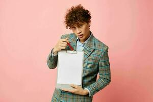 cute red-haired guy in a business suit copy-space documents pink background unaltered photo