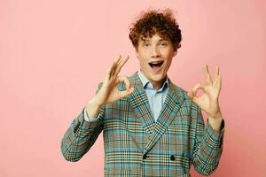 Young curly-haired man gesturing with his hands emotions checkered jacket Lifestyle unaltered photo