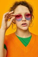 cheerful woman orange sweatshirts sunglasses multicolored glasses supply cropped view unaltered photo