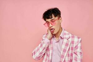 Photo of romantic young boyfriend pink glasses checkered jacket fashion posing pink background unaltered