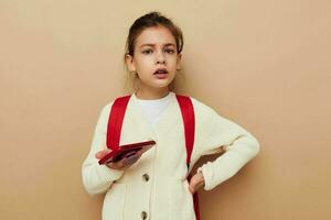 pretty young girl talking on the phone with a backpack childhood unaltered photo