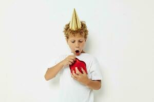 little boy wearing a white t-shirt with a cap on his head birthday gift photo