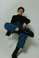 pretty woman sitting on a chair in a black jacket fashion posing Lifestyle unaltered photo