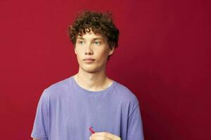 portrait of a young curly man hand gestures heart shaped glasses posing isolated background photo