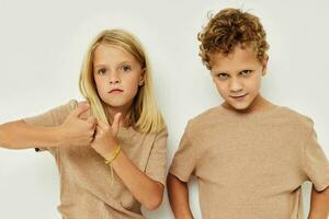 Boy and girl gesticulate with their hands together childhood unaltered photo