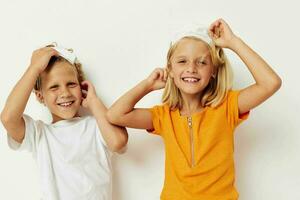 picture of positive boy and girl fun medical mask stand side by side close-up light background photo