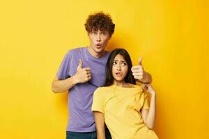 cute young couple in colorful t-shirts posing friendship fun isolated background unaltered photo