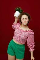 women in green shorts and pink blouses flower pot home unaltered photo