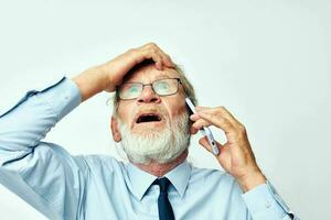 old man with phone surprised in studio on white background photo