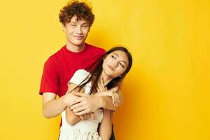 young boy and girl Friendship posing hugs together yellow background unaltered photo