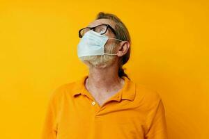 Photo of retired old man medical mask on the face protection close-up isolated background