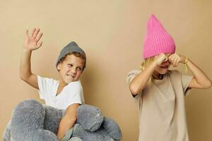 Photo of two children in hats with a teddy bear friendship Lifestyle unaltered