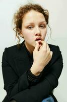 portrait of a young woman elegant style black blazer posing light background unaltered photo